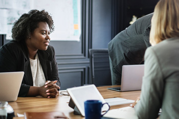 People in an office meeting together.