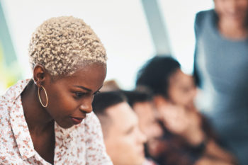 Woman helping a colleague in an office environment.