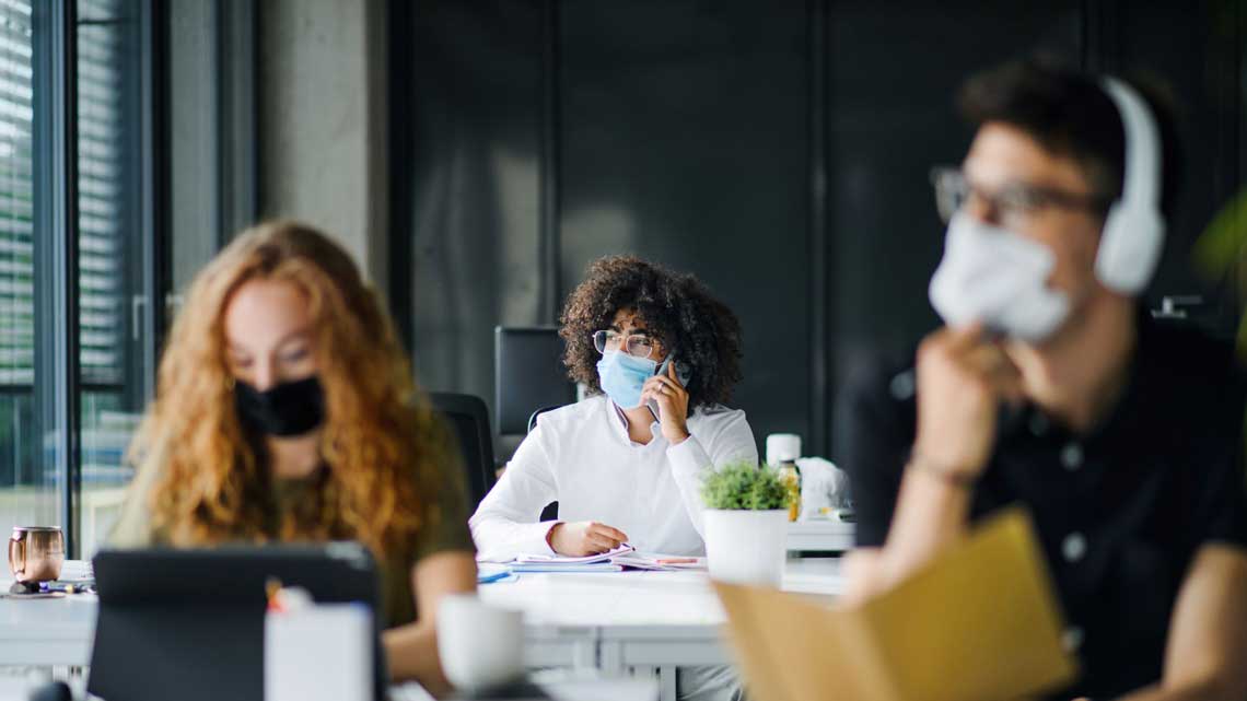Office workers wearing masks.