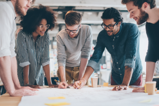Team of colleagues looking over a plan together