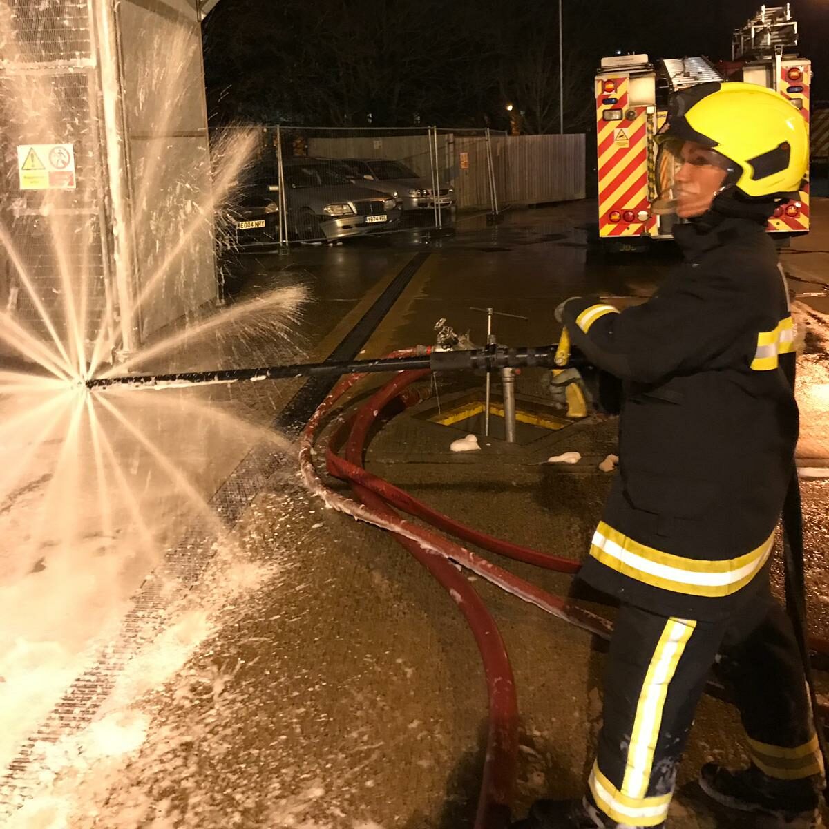 Action shot of Laura Hutchings working as a firefighter.